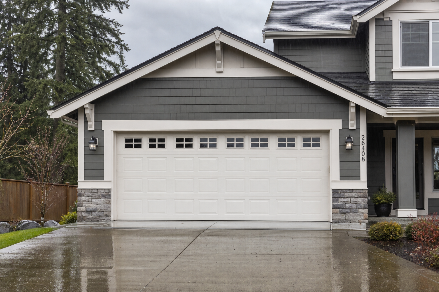 Wide view of a sealed garage door outside a Duvall home on a rainy day